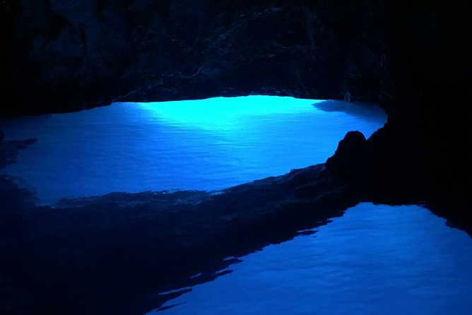 Private Blue and Green Cave Tour from Hvar Town - Stiniva Cove: swimming through the rocky entrance