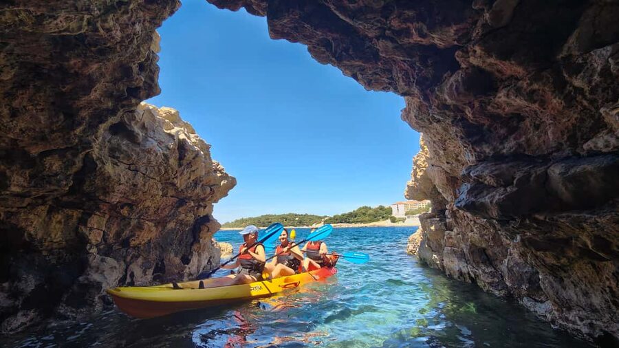 Pula: Cave Kayak Tour, Snorkeling and Island Jumping - Paddling the coast toward the cave